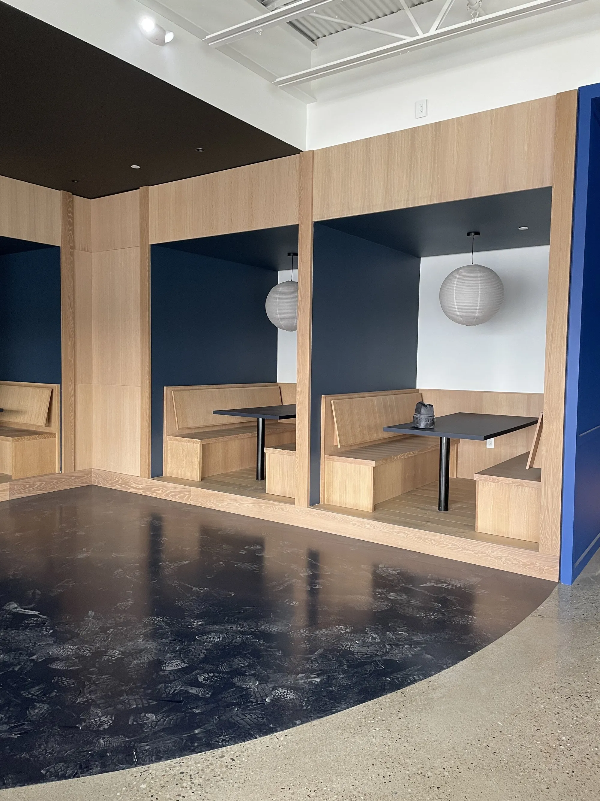 Custom wood booth seating with blue accent walls