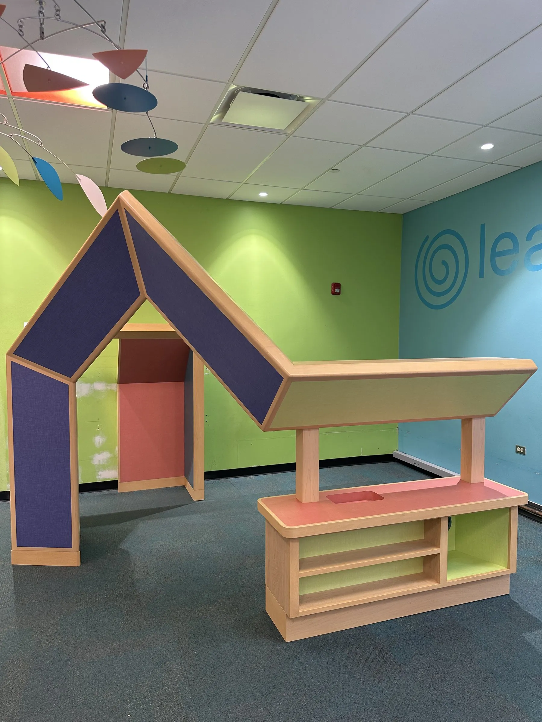 Colorful custom millwork seating in a children's learning space
