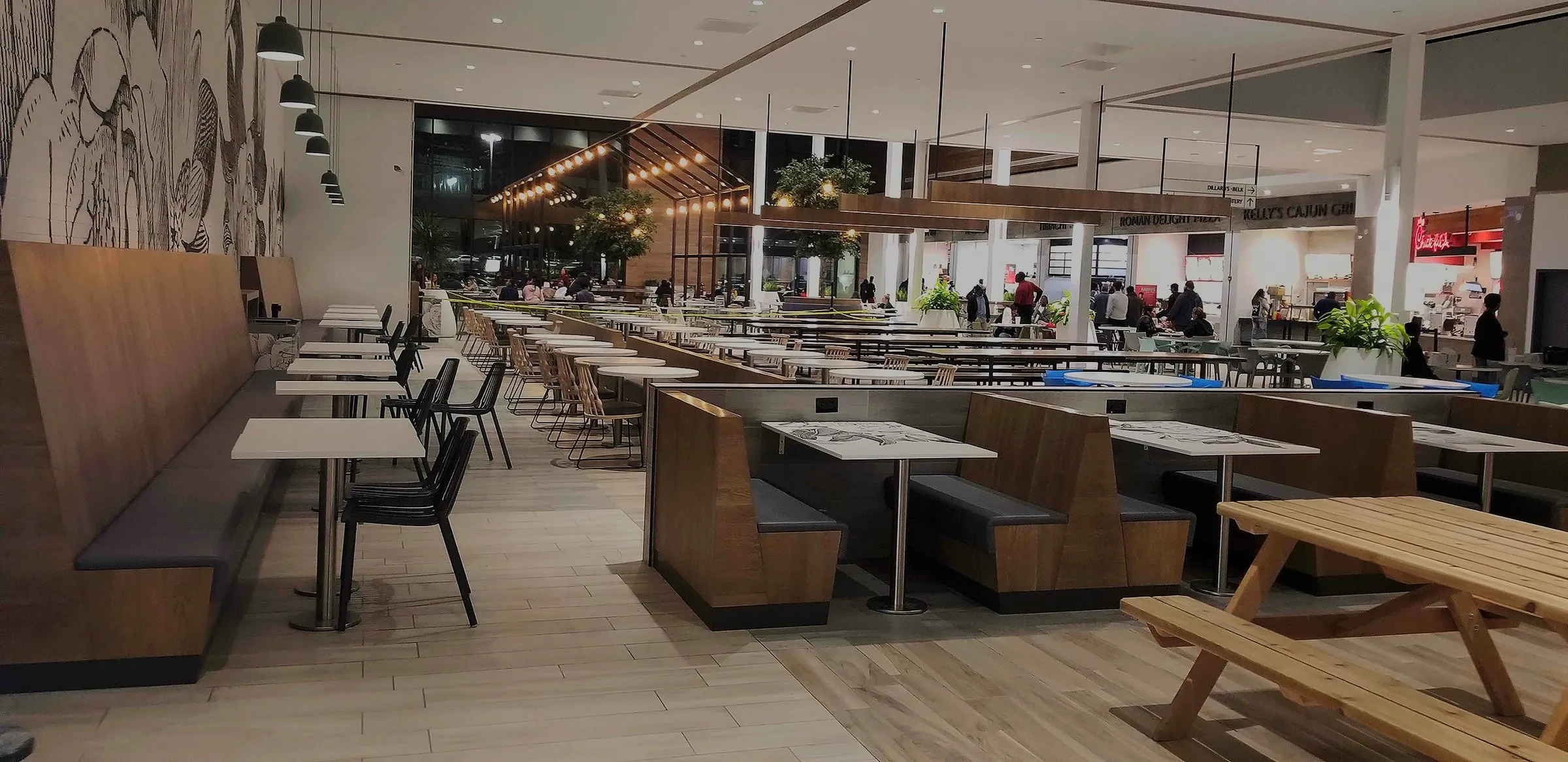 Modern shopping-mall food court with custom wood booth seating