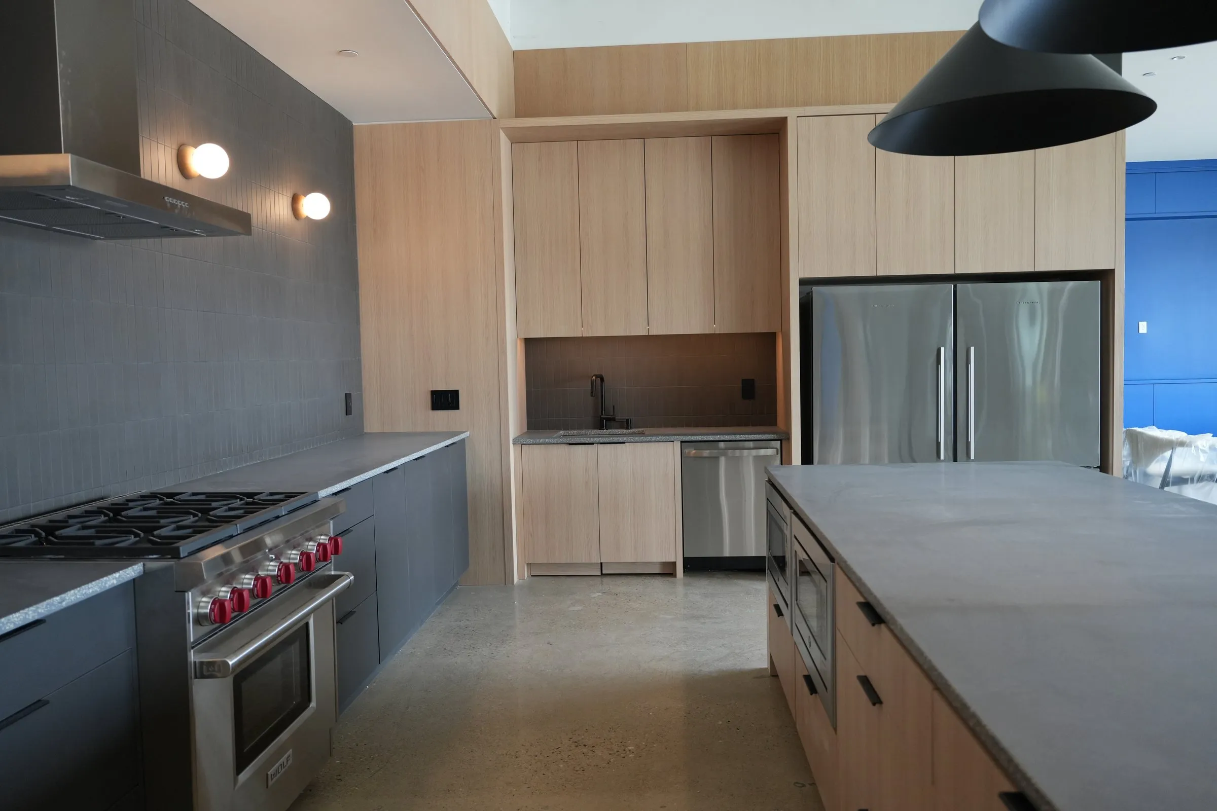 Luxury custom kitchen with white-oak cabinetry and Wolf range