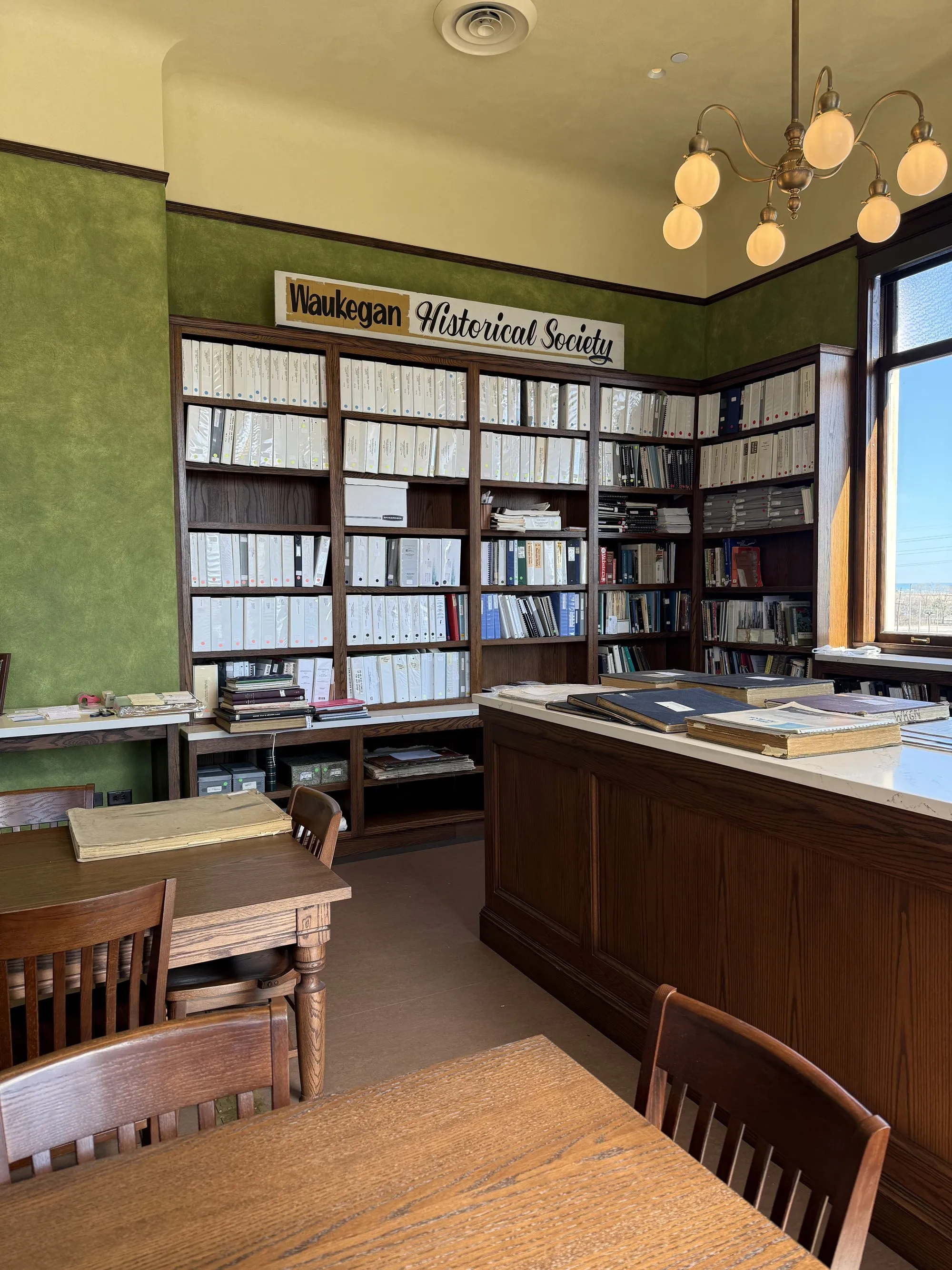 Carnegie library reading room with green walls and custom reference table