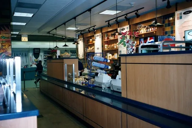 Custom deli and café service counter with display casework and overhead shelving