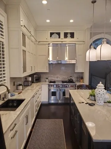 Custom white kitchen with marble countertops