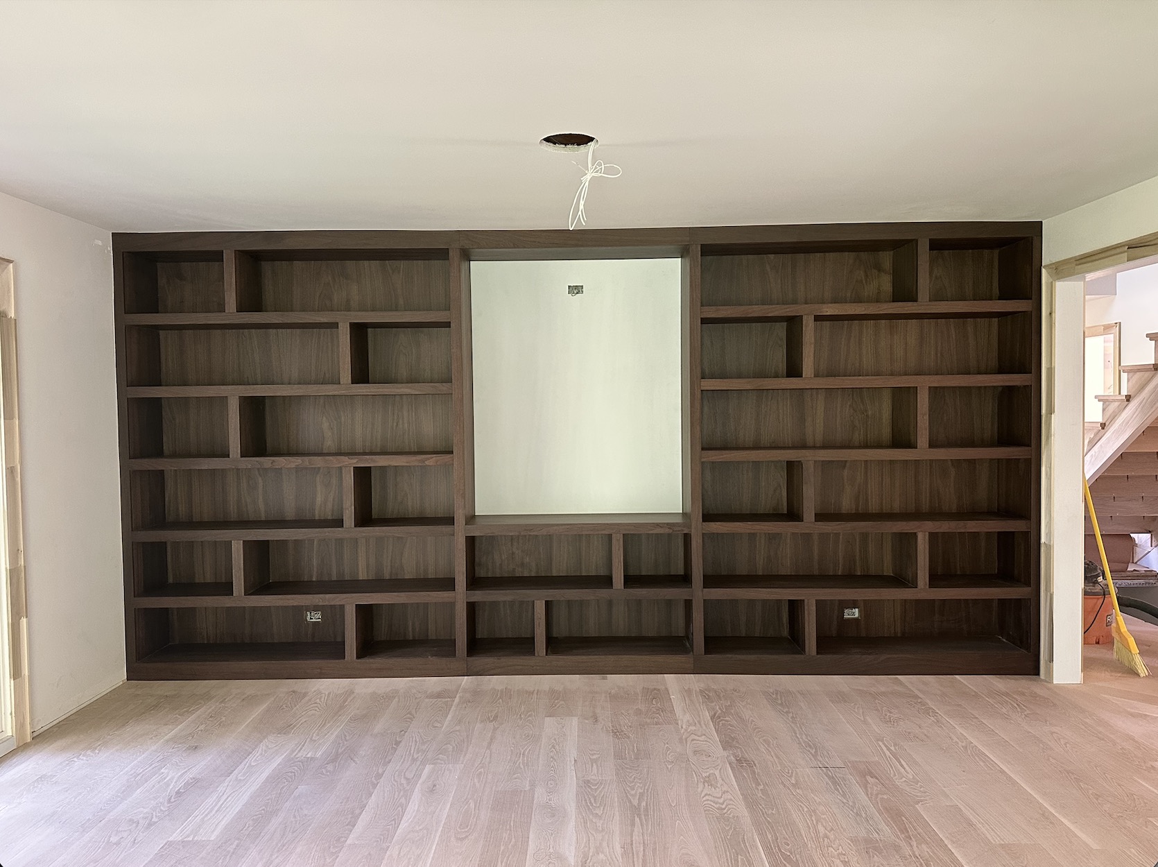 The finished Turano walnut bookcase wall installed on site